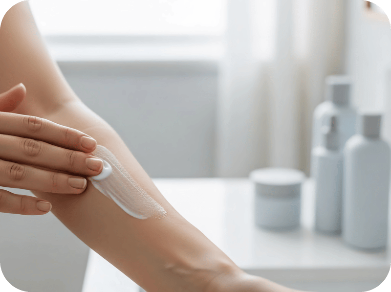 Applying cream to a womans inside forearm Square-modified