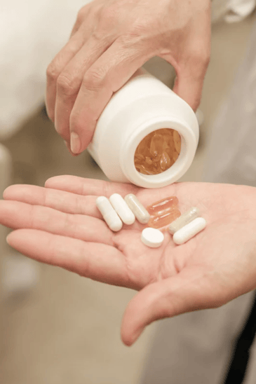 Woman Pouring Vitamins